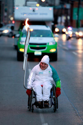 Day 52 Torchbearer 11 Chad Pilon carries the flame in Hamilton, Ontario.