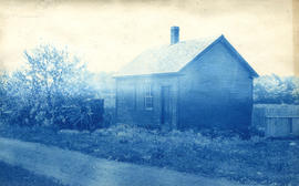 [View of small building with buggy in front]