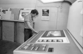 Unidentified man examines Toni Onley Centennial Art Series print at Agency Press