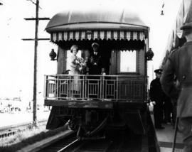 [King George VI and Queen Elizabeth standing on platform of last car of Royal Train]