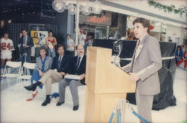 Unidentified man speaking from podium