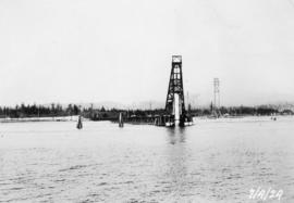 Pile driver putting in a pier : April 7, 1924