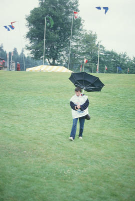 Woman holding an inside out umbrella during the Centennial Commission's Canada Day celebrations