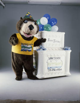 Tillicum standing beside large birthday cake