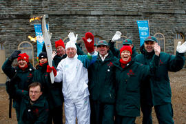 Day 36 Torchbearer 17 Jean Cauchy poses for a photo with Parks Canada at Fort-de-Lévis, Quebec.