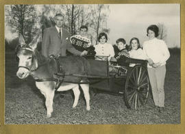 Family around a donkey cart