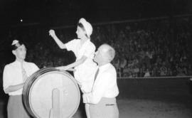 [Mayor Cornett helping girl pick a ticket out of a barrel]