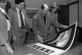 Toni Onley (centre) and group examine his Centennial Art Series print at Agency Press