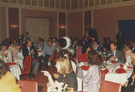 Expo Ernie and Tillicum walking between tables at Wake Up Awards