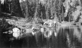 Five hikers at a lake