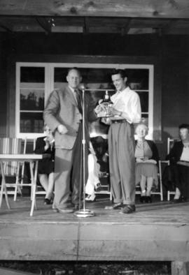 [F.J.] Skinner, [Prince Rupert Agent] presenting ship's bell to Limber Lost Lodge [in Massett]