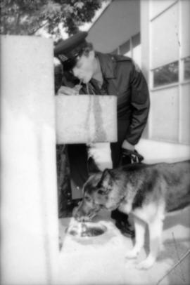 Constable Rob Bosley and police dog Sport at drinking fountain