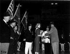 Miss P.N.E. Glenda Sjoberg presented with flowers at event including Gizeh Shrine Divan members, ...