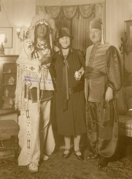 Adaline Hendry flanked by two men in costume