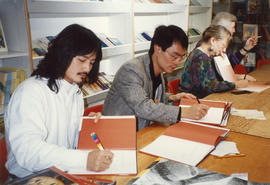 Paul Yee and illustrator Simon Ng signing copies of Tales from Gold Mountain at Children's Book C...