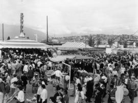 Crowd around CKWX remote location, concessions, and tents on P.N.E. grounds