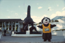 Tillicum beside Bill Reid orca sculpture at the Vancouver Aquarium