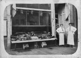 McDowell and Kinnis standing outside their shop at 704 Granville Street