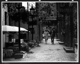 [Couple walking near Blood Alley] in Gastown