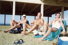 John [and two unidentified people sunbathing]