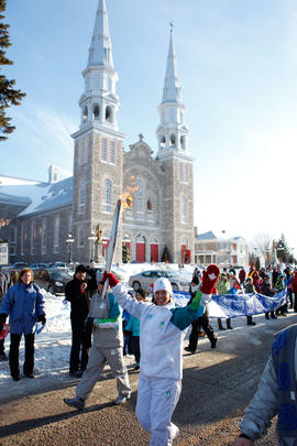 New -  Day 43 Torchbearer 24 Guylaine Plante carries the flame in Saint-Jacques, Québec.