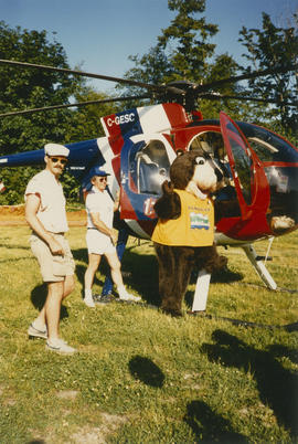 Tillicum and two men beside helicopter