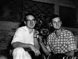 Men posing with cattle in Livestock building