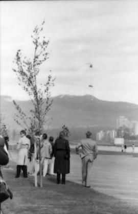 Group watching helicopter from parking lot