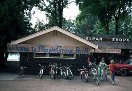 [Bicycles, children, and welcome banner at Maple Grove Park]