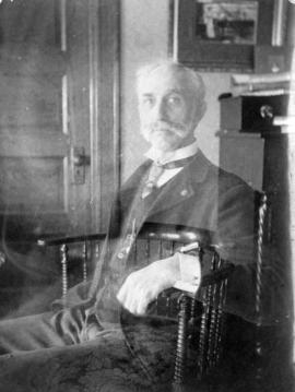 [Self-portrait - Osborne J. Pierce sitting in a chair]