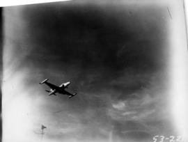 Plane flying over P.N.E. grounds in Aviation and Transportation Day fly past event