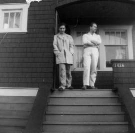 Two men on front steps of house