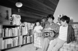 Woman and two young children on a couch