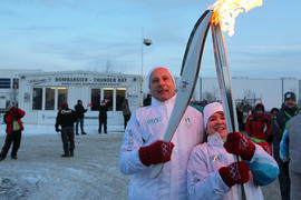 Day 67 Torchbearer 4 Annick Harvey is passing the flame to Torchbearer 5 André Navarri in from of...