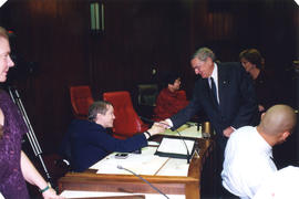 Roméo LeBlanc shaking hands with Sam Sullivan in council chambers