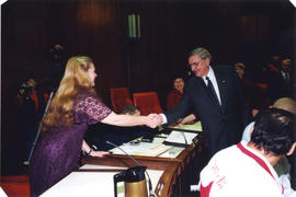 Roméo LeBlanc shaking hands with Nancy Chiavario in council chambers