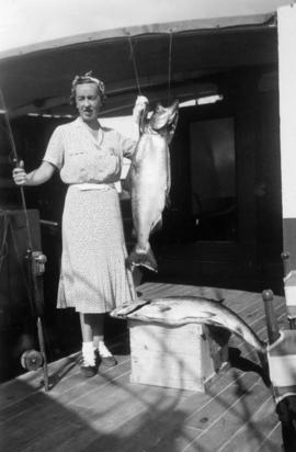 A woman showing off her catch aboard the Vencedor