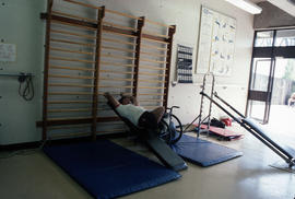 [Man with wheelchair in exercise room]