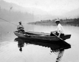 [Unidentified man and woman fishing in a boat]