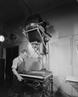 Studio shots with lights, enlargers, etc. [Gordon Orville in studio with lights, enlarger]