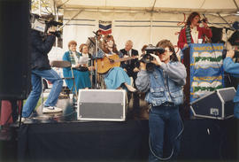 Megan Metcalfe with guitar on Chevron stage during Vancouver AM sign unveiling at Oak Street and ...