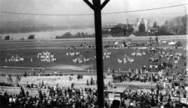 May Day celebrations at Exhibition Park, children dancing around maypoles