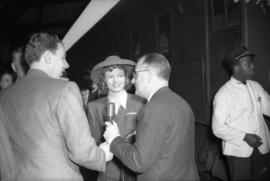 [Miss Anna Neagle being interviewed for radio at the train station]