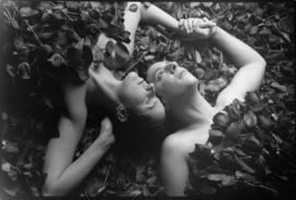 Portrait of two women lying in roses [Curtis Lord]