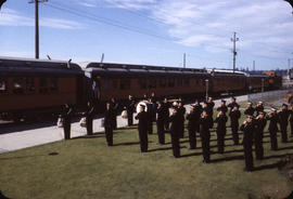 Marching band playing by Pacific Great Eastern train