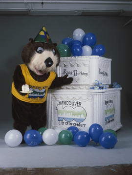 Tillicum standing beside large birthday cake