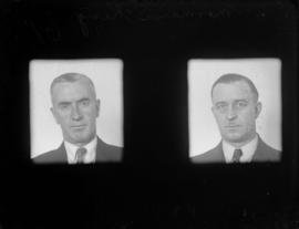 [two unidentified men - police or civic personnel]