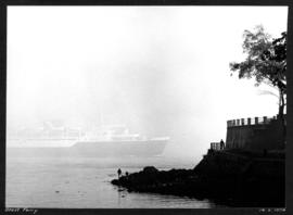 Ghost ferry [ferry passing through fog with Sea Wall in the foreground]