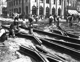[Men laying streetcar tracks at Hastings and Main Streets for reconstruction of Hastings, Main, a...