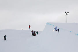 Day 83 Tyler MacRae carries the flame on a snowboard at the Canada Olympic Park in Calgary, Alberta